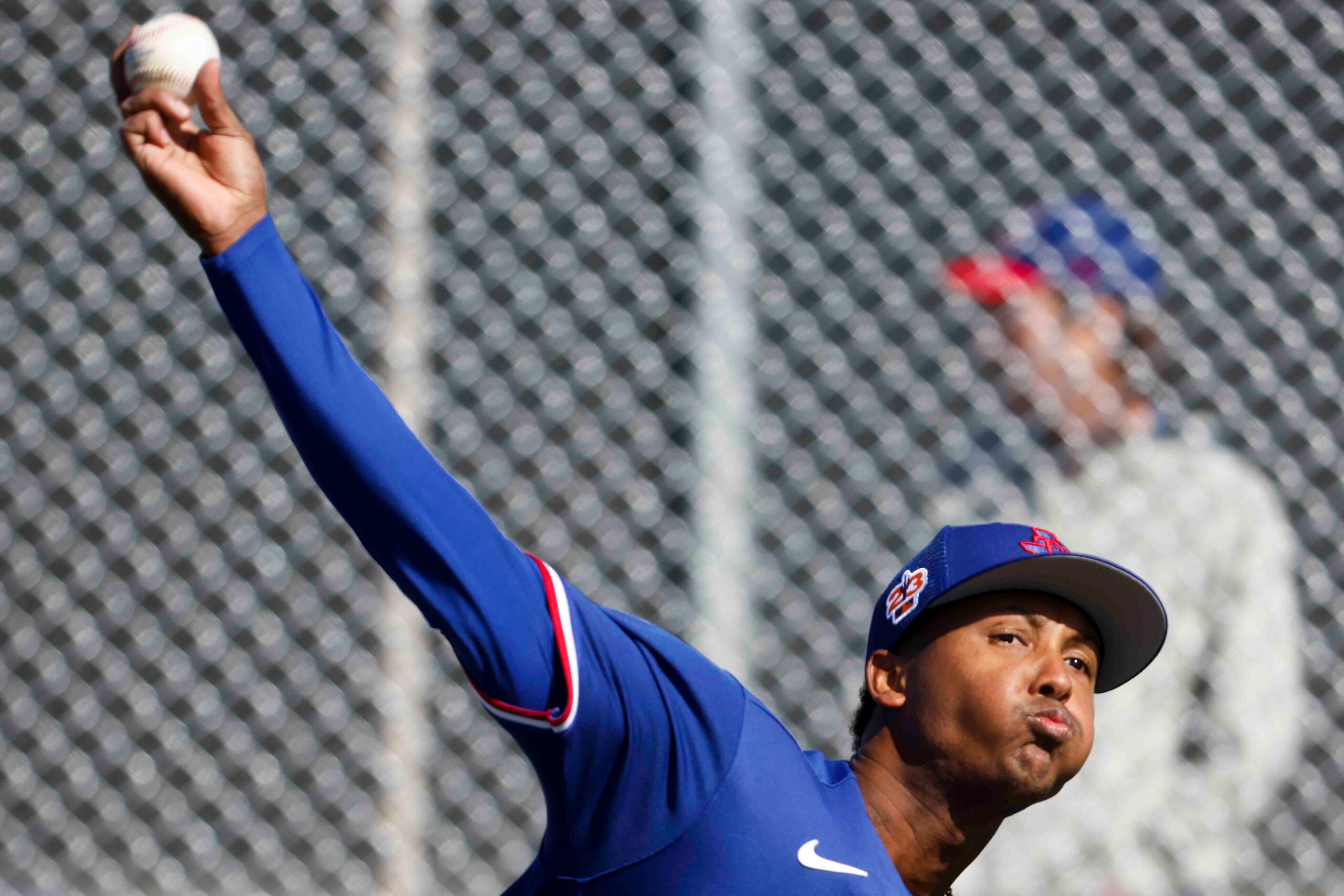 Texas Rangers right handed pitcher Jose Leclerc throws a pitch during a spring training...