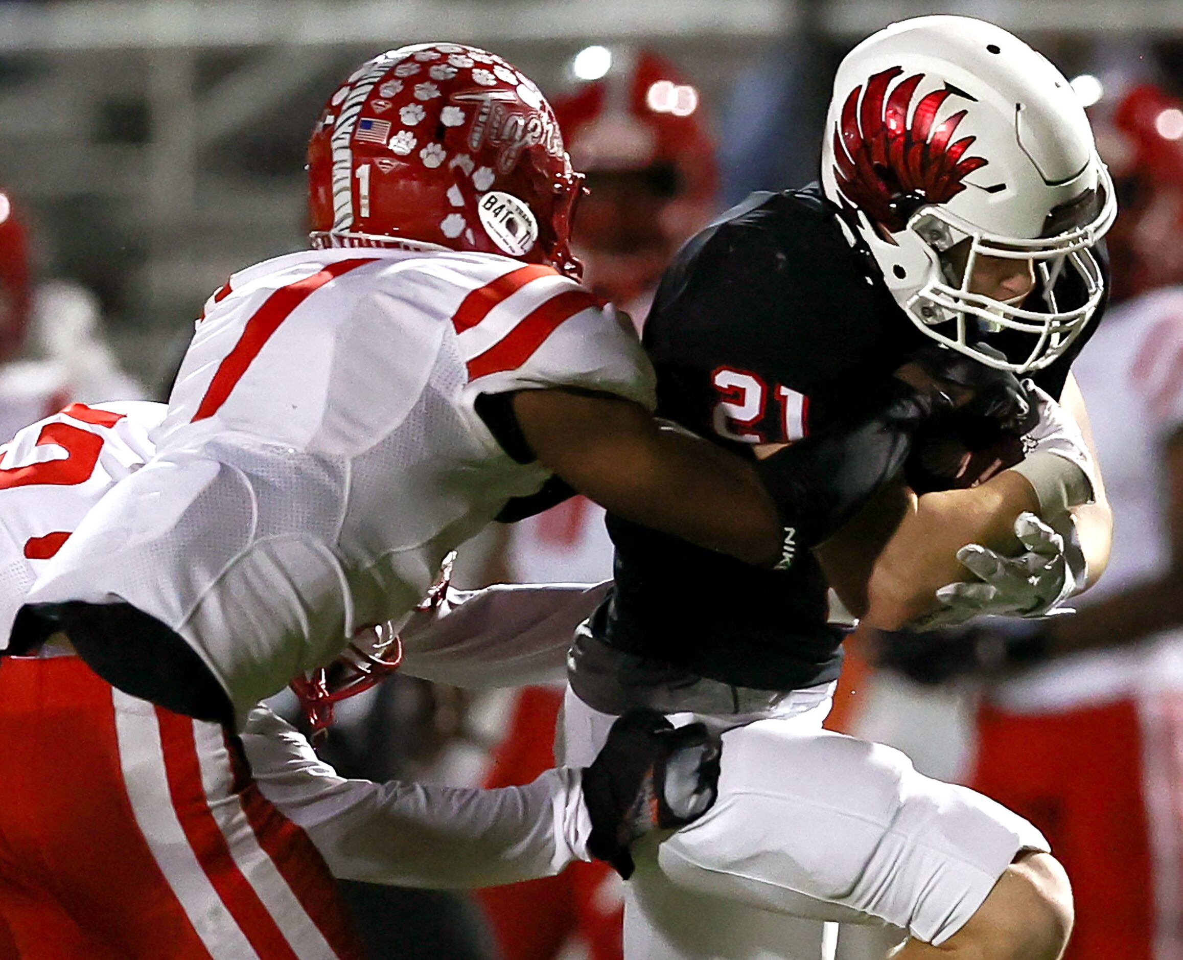 Argyle running back Peyton Shoemake (21) gets wrapped up by Terrell cornerback Kanye Nix (1)...