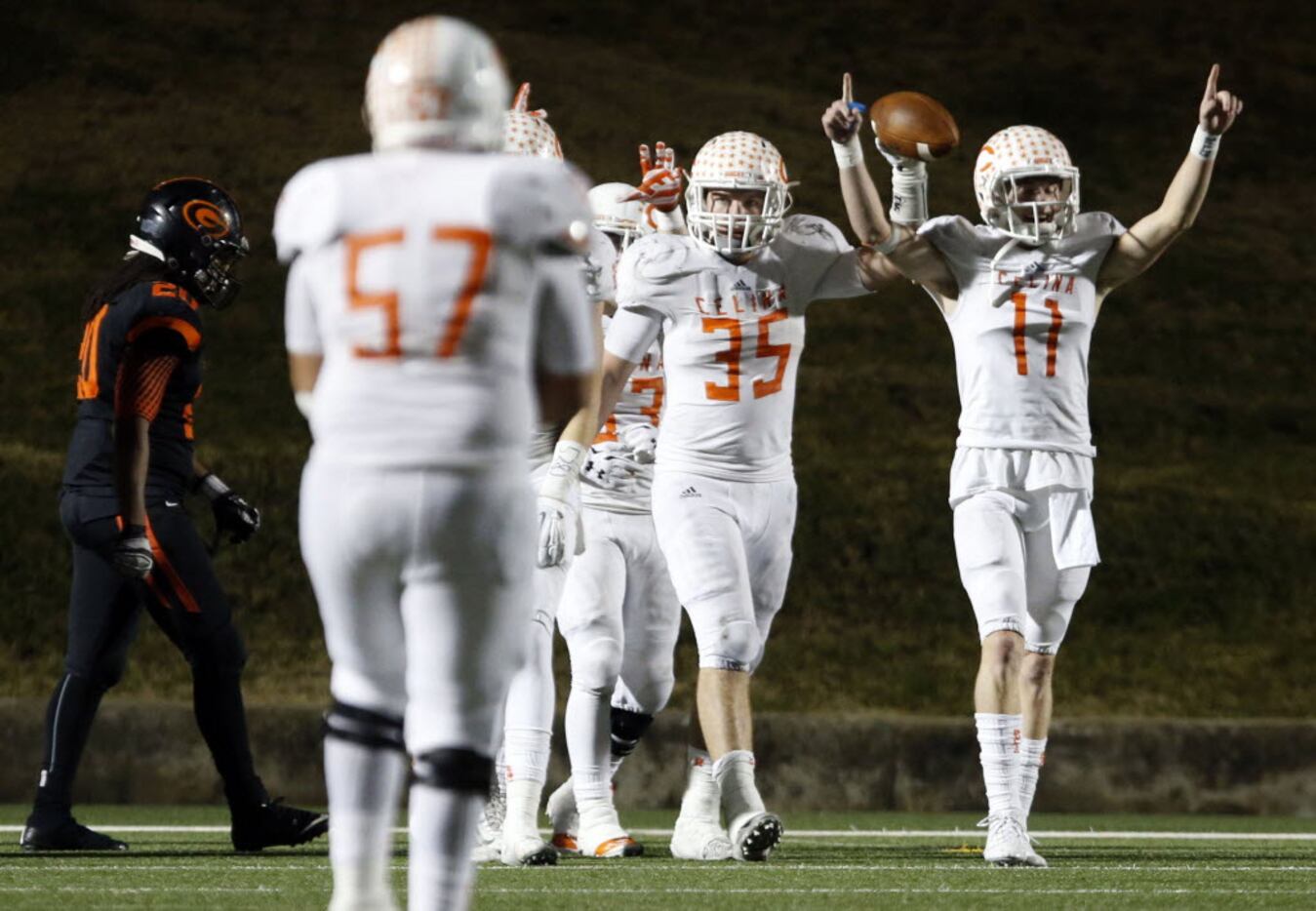 (TXHSFB) Celina High's Shane Gerths (35) holds the football high, as he celebrates with...