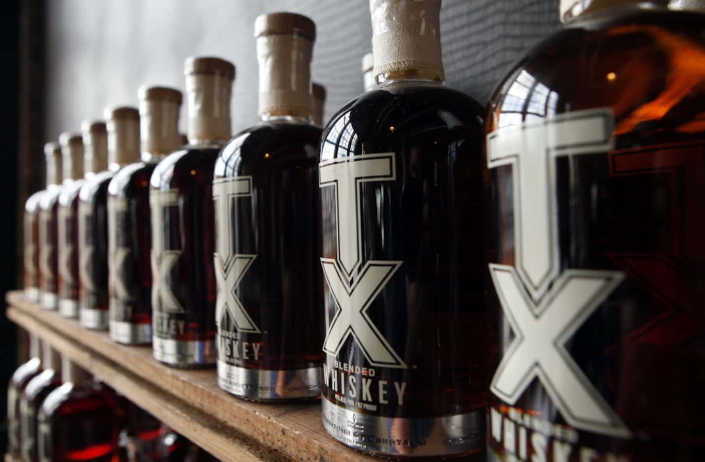 Bottles of blended whiskey on the shelf at the Firestone and Robertson Distilling Company in...