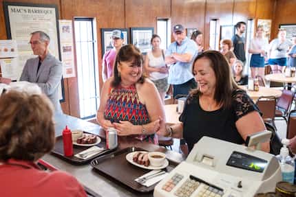 Longtime customers Andrea Houghton, center, and Laurie Shaver, right, joke with employee...