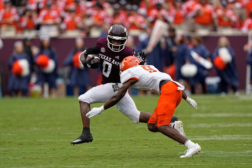 Texas A&M wide receiver Ainias Smith (0) tries to avoid being tackled by Sam Houston State...