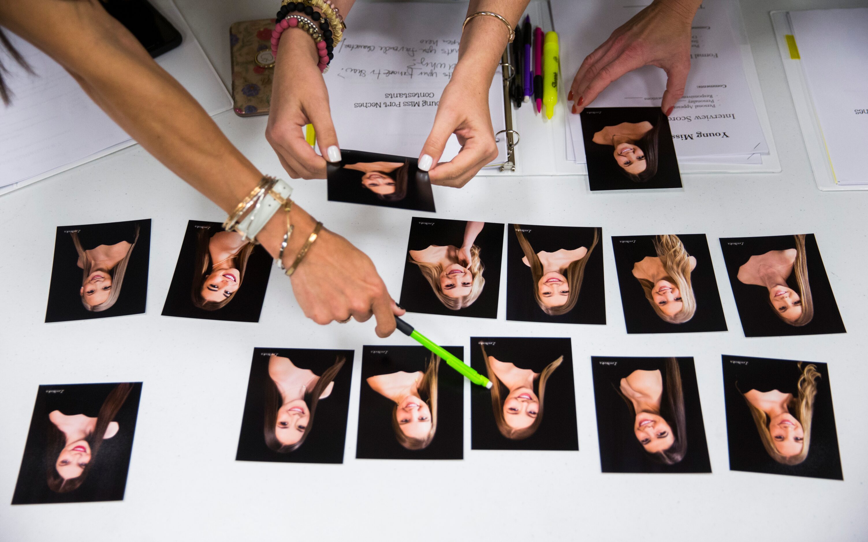 Pageant judges study photos to determine which of the 2019 Miss Port Neches contestants will...