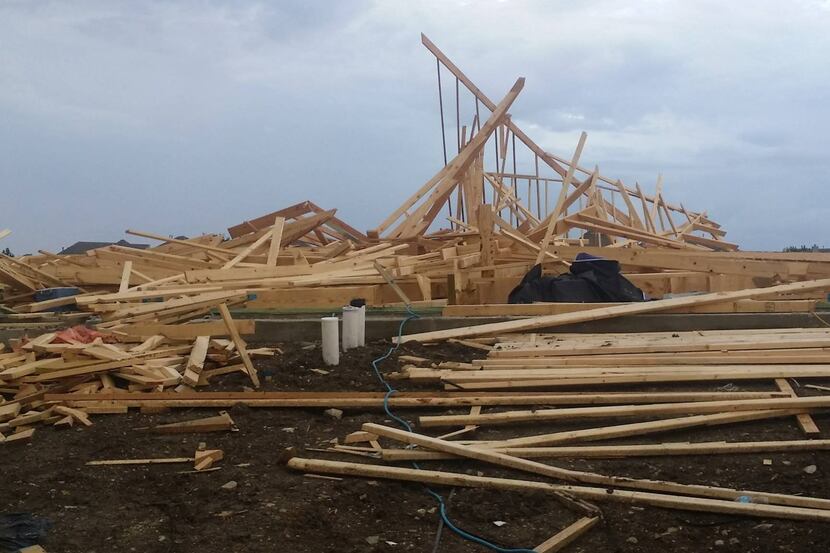 
High winds in Frisco collapsed the frame of a house under construction in the Saddlebrook...