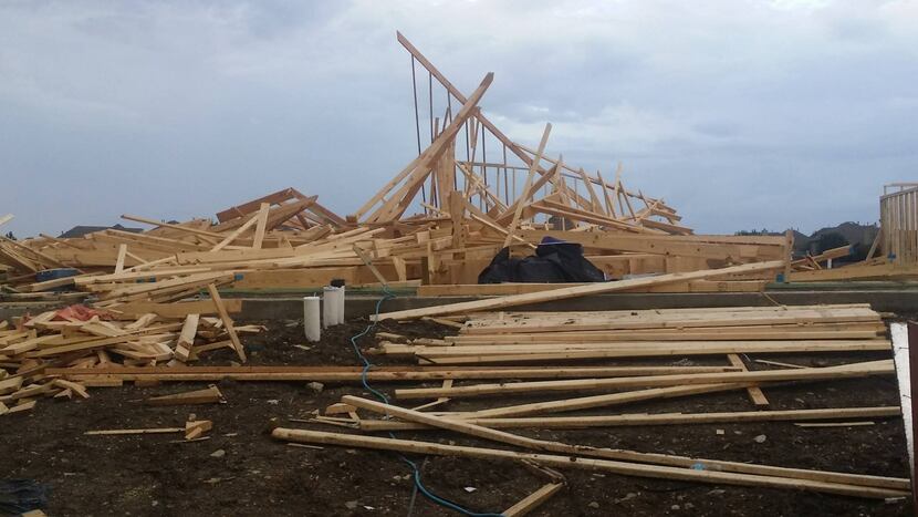 
High winds in Frisco collapsed the frame of a house under construction in the Saddlebrook...