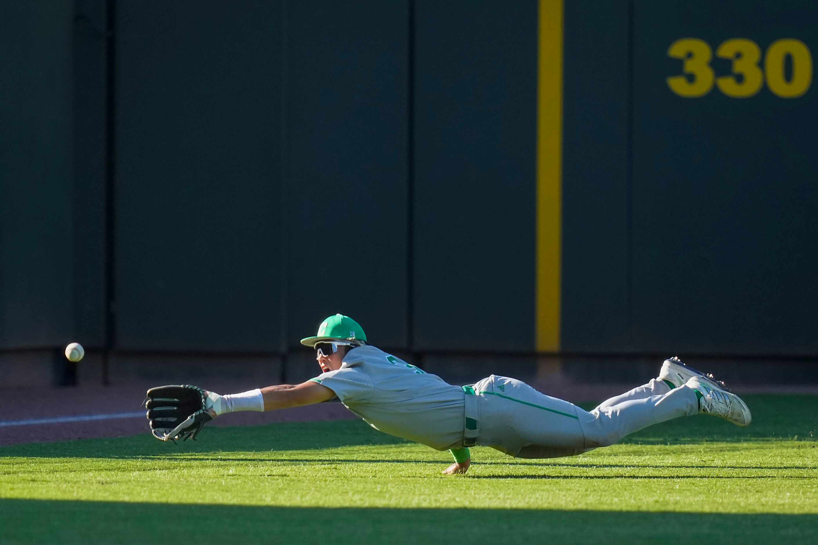 Southlake Carroll left fielder Max Reyes can’t come up with a diving catch during the sixth...