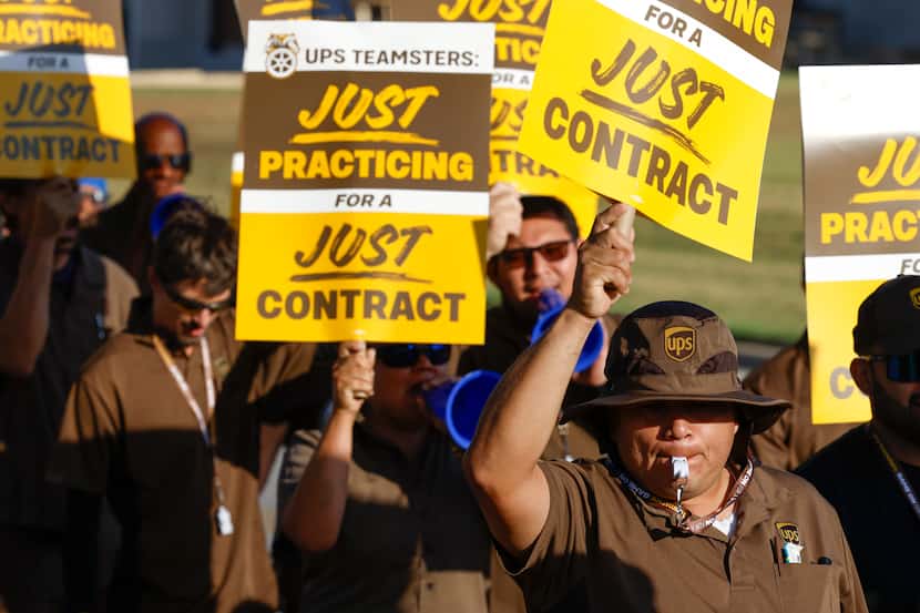 UPS employees take part in a picketing practice on Wednesday, July 12, 2023, in Dallas. UPS...