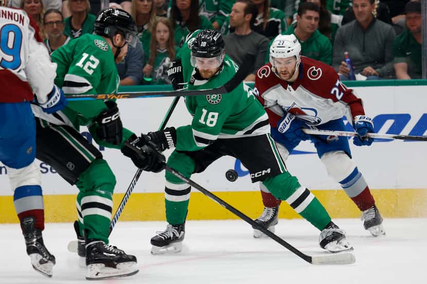 Dallas Stars center Radek Faksa (12) and center Sam Steel (18) try to wrangle a loose puck...