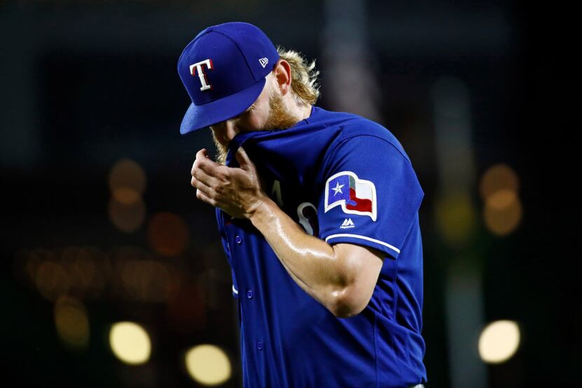 Texas Rangers starting pitcher Andrew Cashner walks off the field after being removed during...
