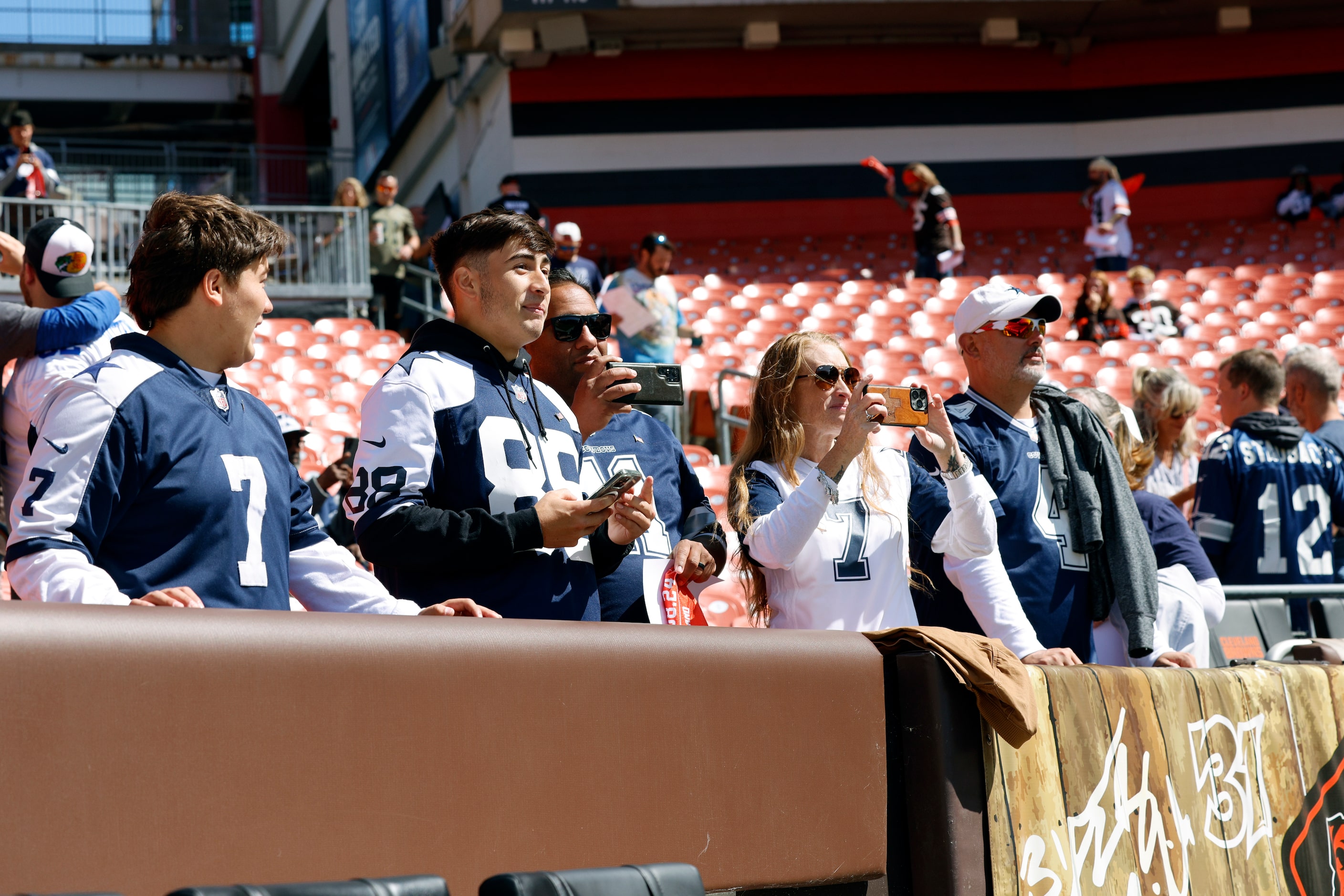 Dallas Cowboys fans watch as players warm up before the first half against the Cleveland...