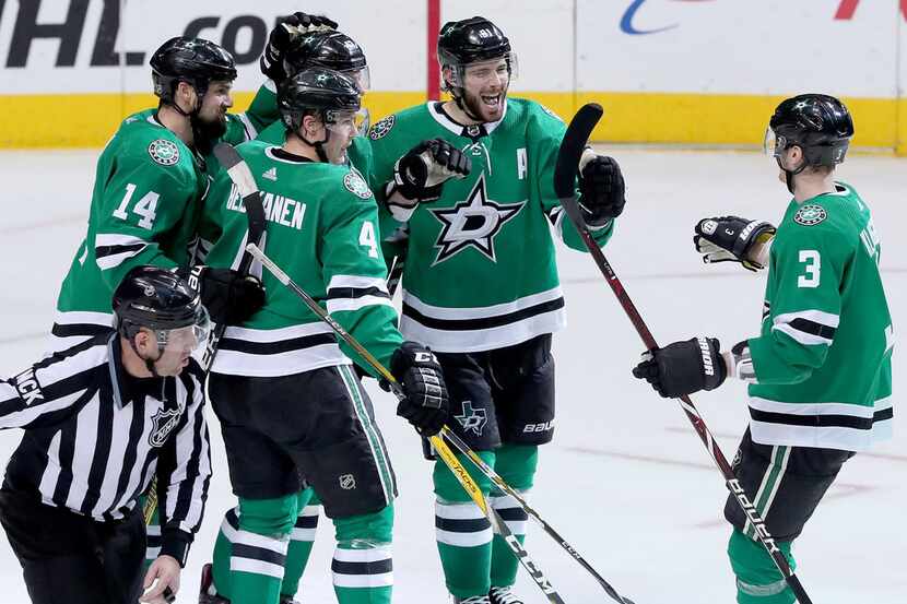 DALLAS, TEXAS - JANUARY 19: Tyler Seguin #91 of the Dallas Stars celebrates with John...