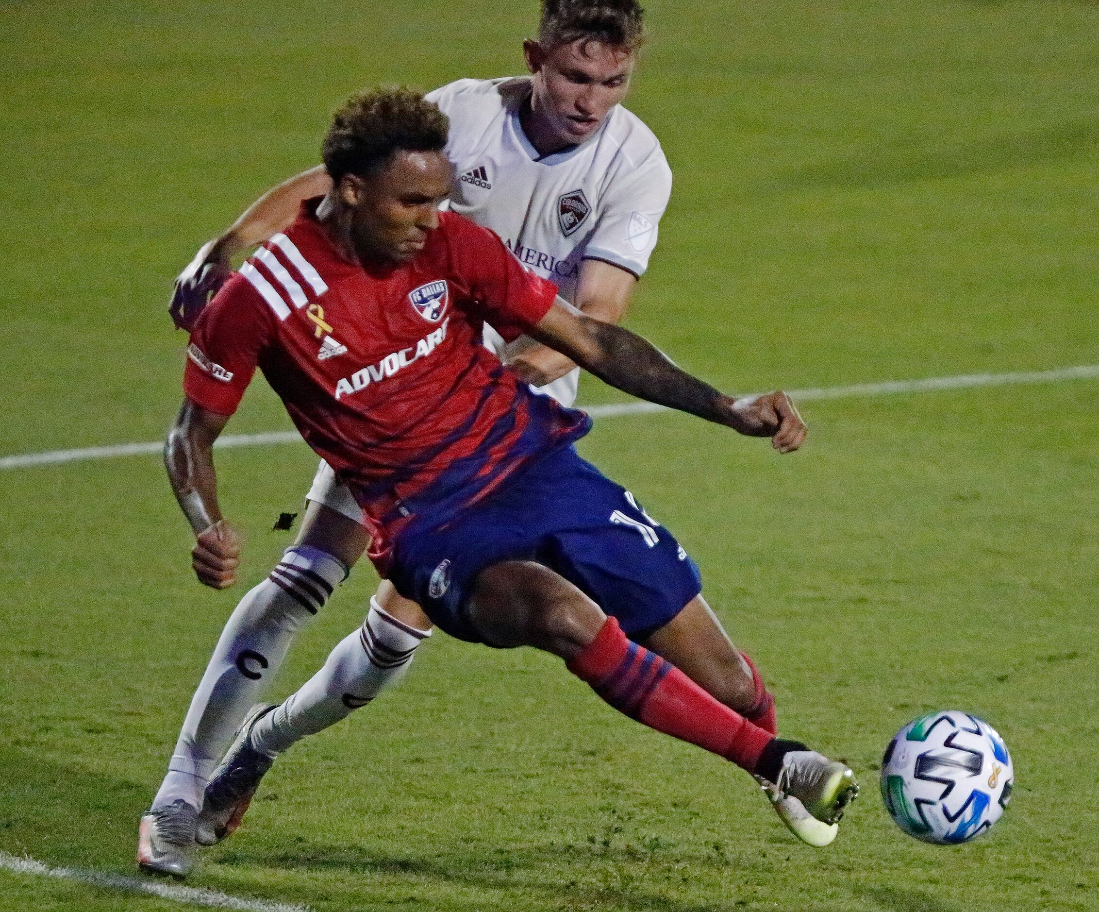 FC Dallas forward Bryan Reynolds (14) leaves his feet as he takes a shot on goal in front of...