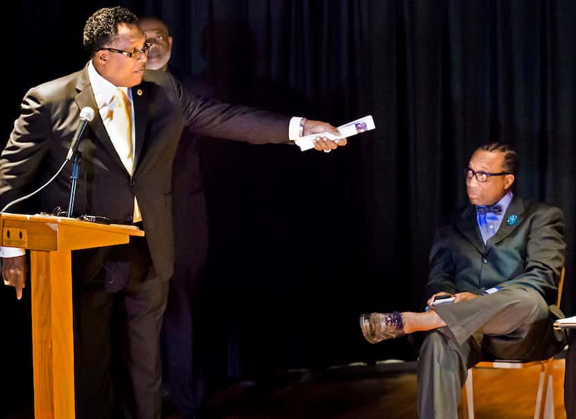 Dwaine Caraway (left) motions to incumbent John Wiley Price as Democratic primary candidates...