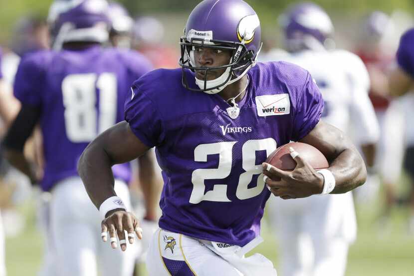 Minnesota Vikings running back Adrian Peterson carries the ball during NFL football training...