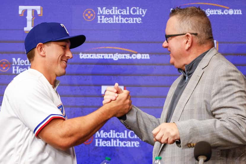 Texas Rangers top pick Wyatt Langford (left) shakes hand with Rangers Senior Director of...