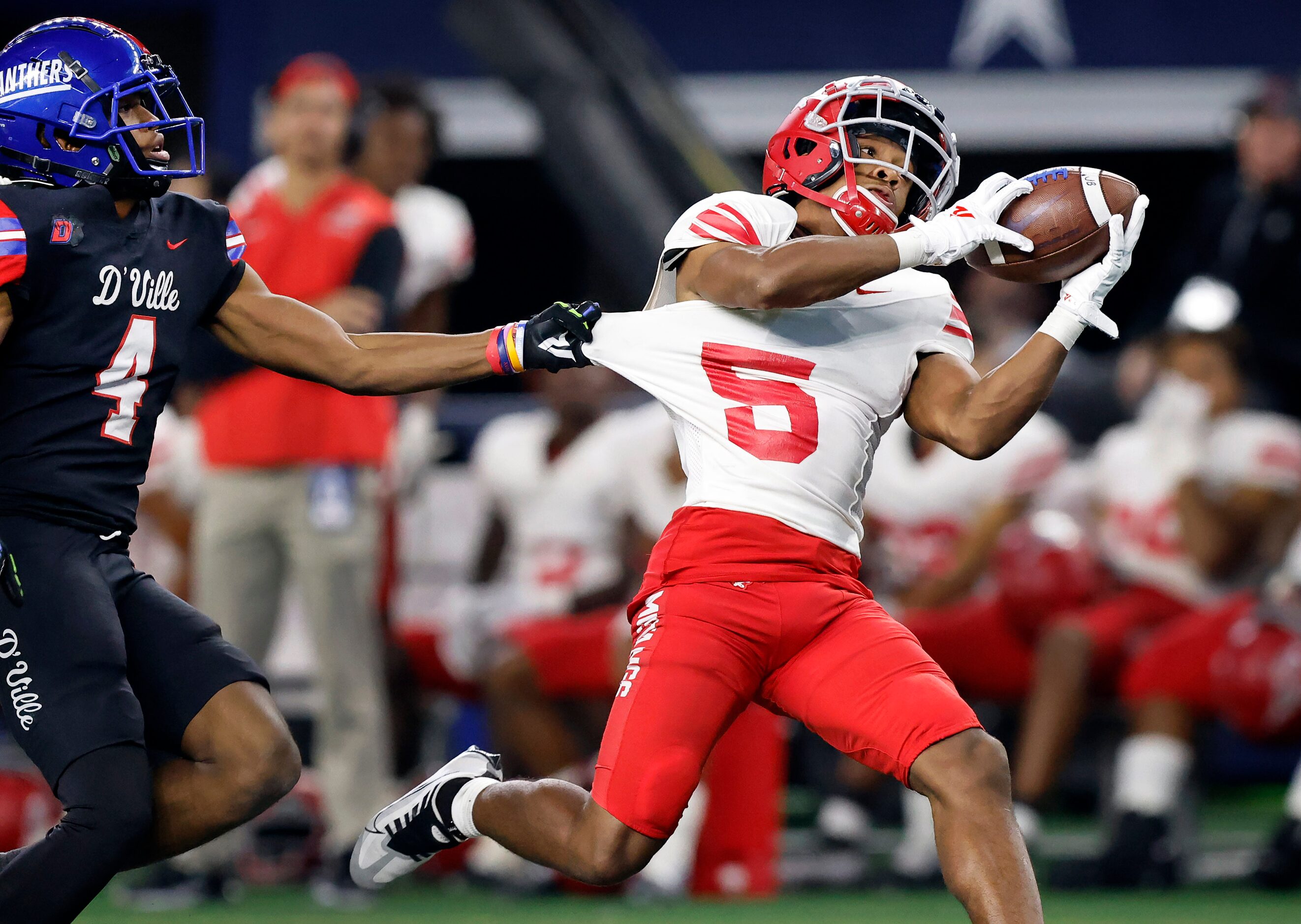 Duncanville receiver Dakorian Moore (4) tries to keep Galena Park North Shore defensive back...