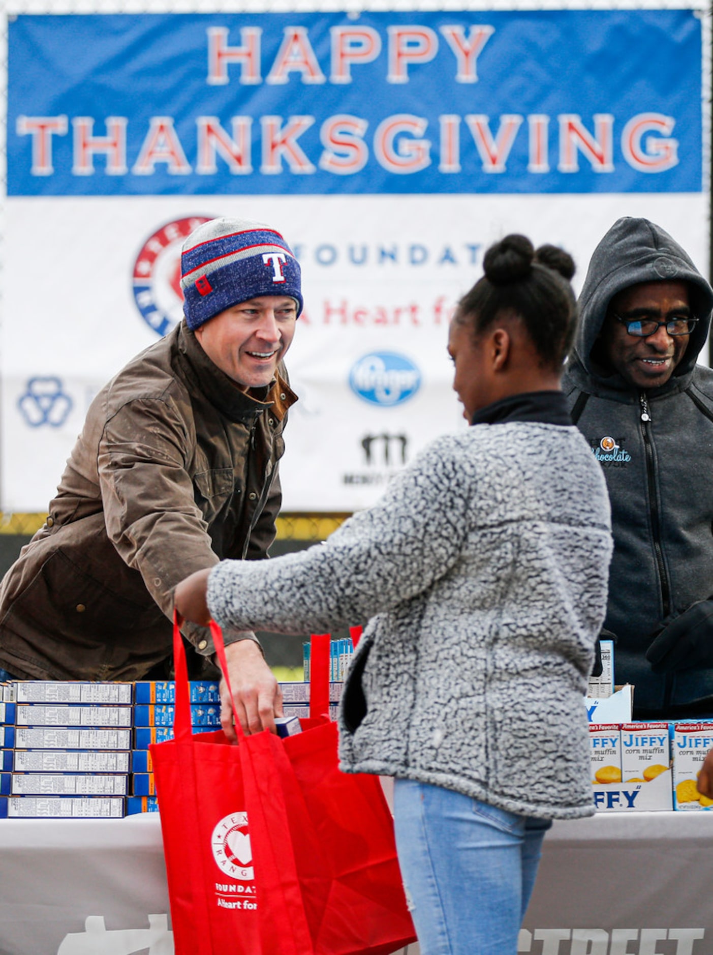 Justin Henry, Manager of Development with the Texas Rangers Baseball Foundation, places a...