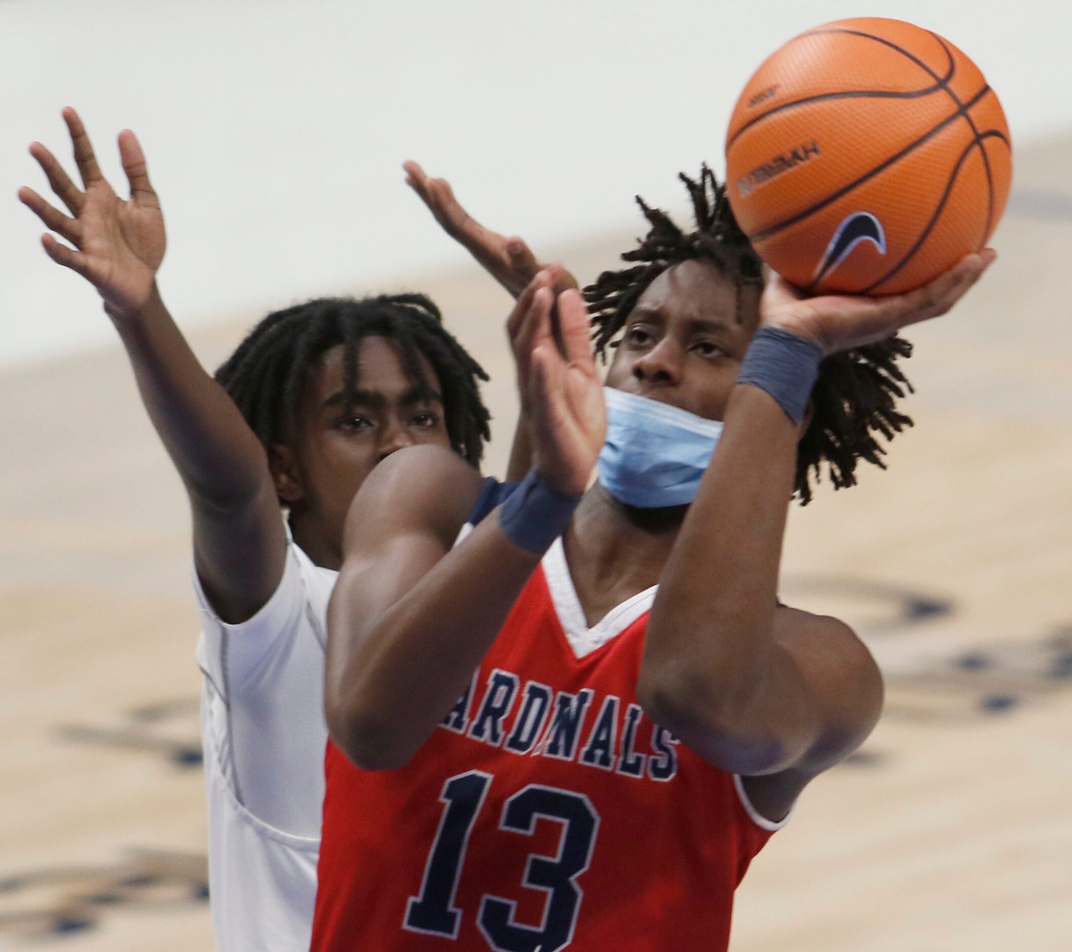 Plano John Paul ll senior Manny Obaseki (13) drives to the basket for two of his first half...