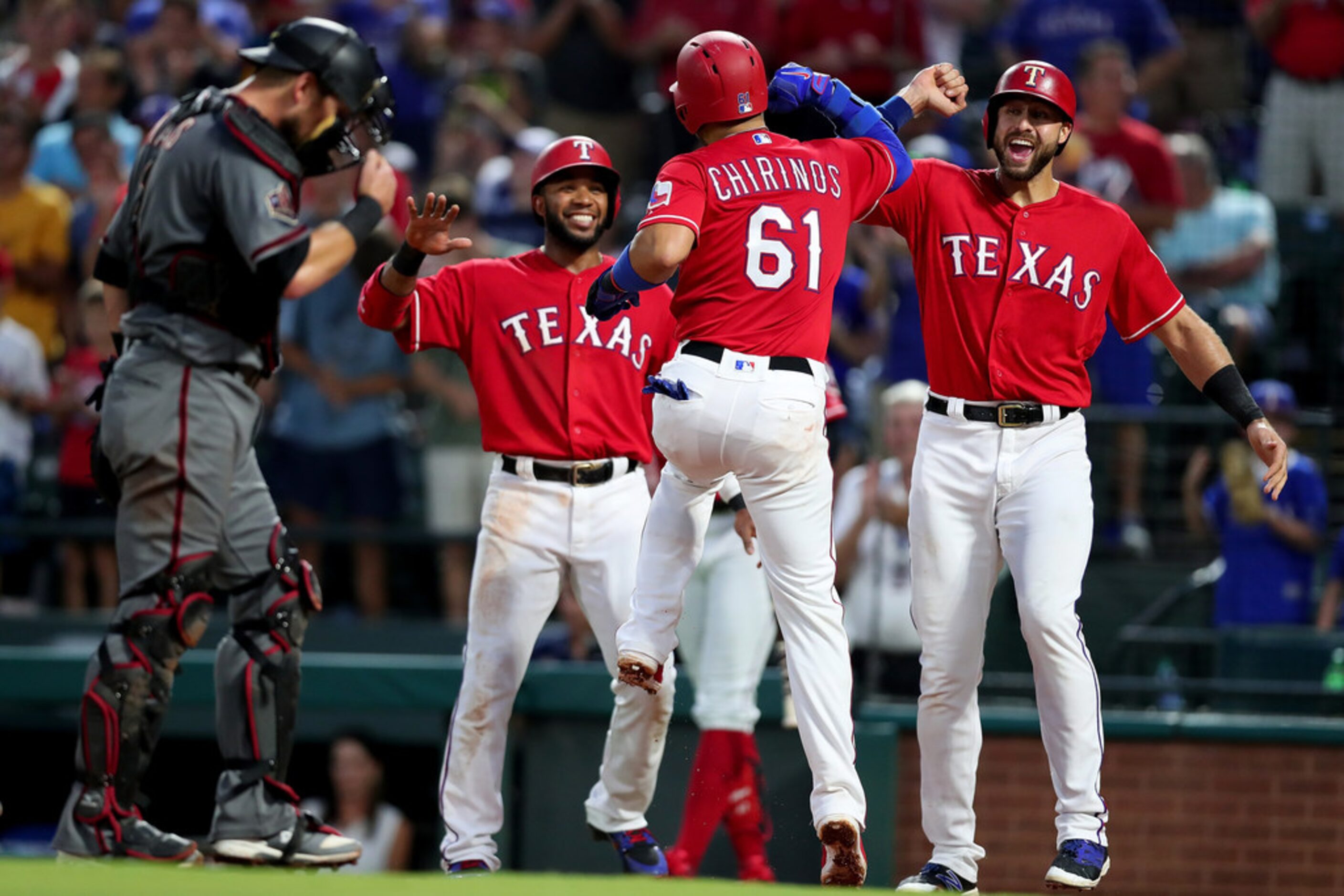 ARLINGTON, TX - AUGUST 13:  Robinson Chirinos #61 of the Texas Rangers celebrates with Elvis...