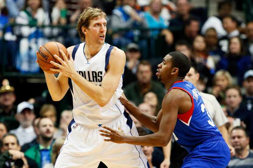 Dallas Mavericks' Dirk Nowitzki, left, of Germany works for an opportunity to the basket...