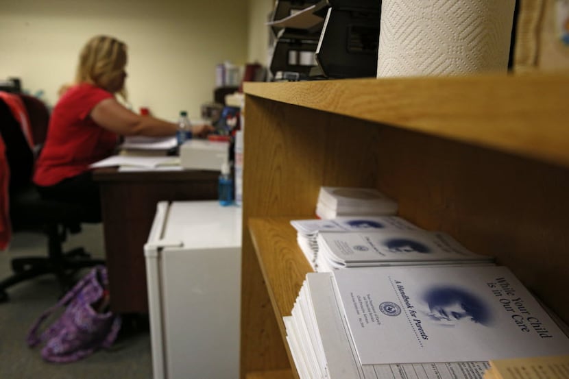 A Child Protective Services child-abuse investigator caught up on paperwork at her Fort...