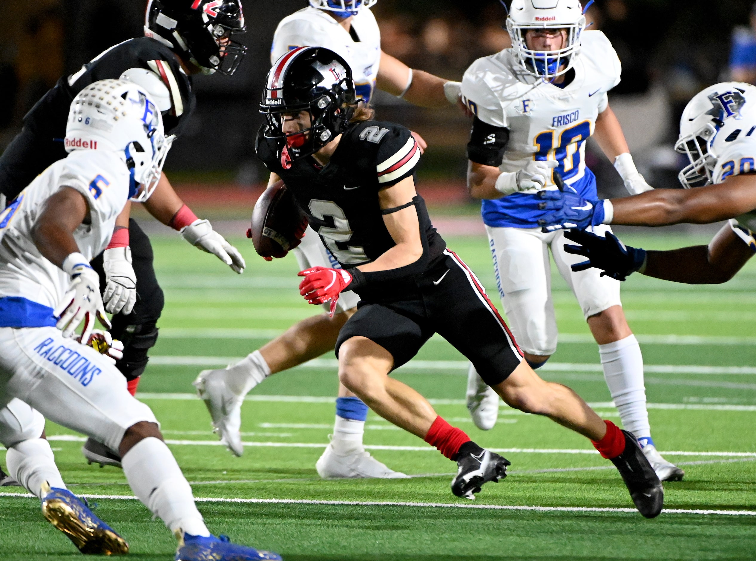 Lovejoy's Jaxson Lavender (2) runs upfield between Frisco's Arron Jamison-Johnson (6) and...