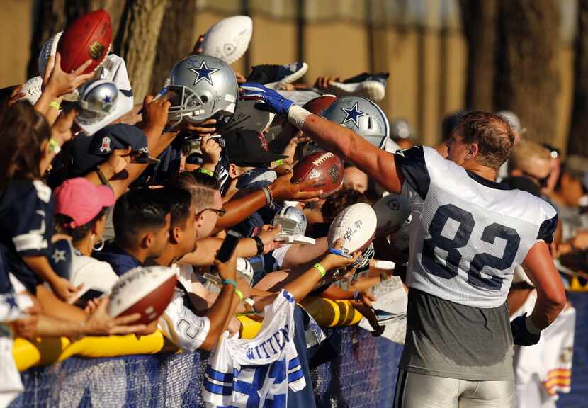 Dallas Cowboys tight end Jason Witten (82) signs autographs for screaming fans following...