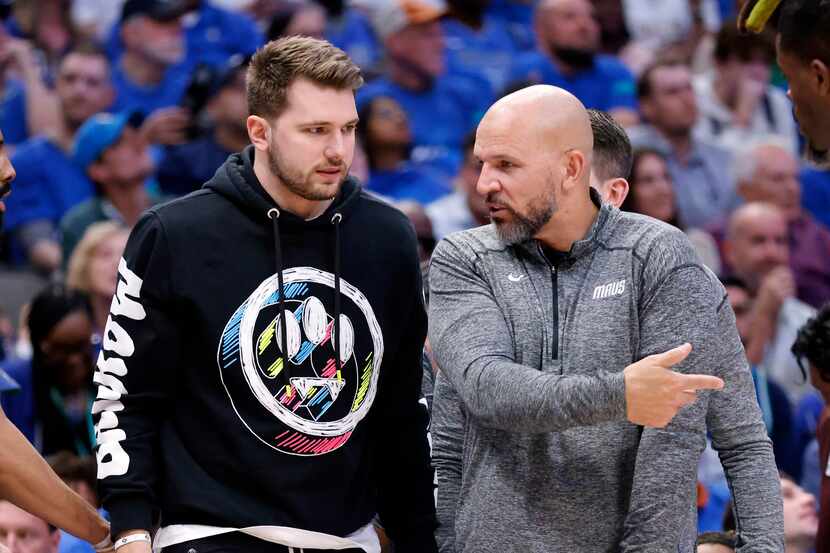 Dallas Mavericks guard Luka Doncic (left) listens to an explanation from head coach Jason...