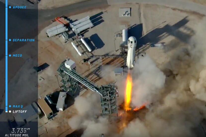 Blue Origin's Shephard rocket takes off from its landing pad Thursday, pictured here in a...