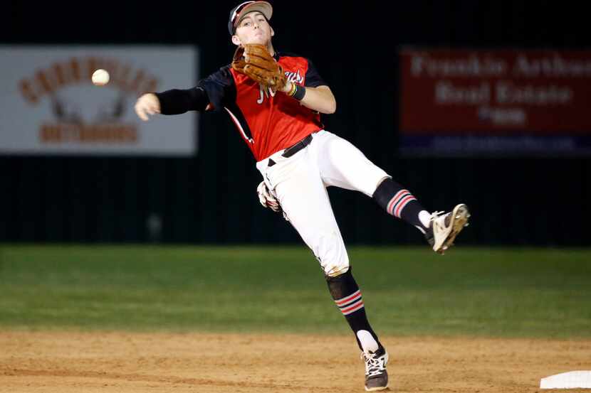 Flower Mound Marcus shortstop Jimmy Glowenke (3) throws out a runner as they played...