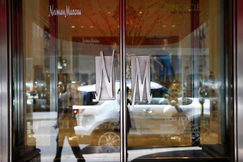 A pedestrian is reflected in the door of Neiman Marcus in downtown Dallas. 