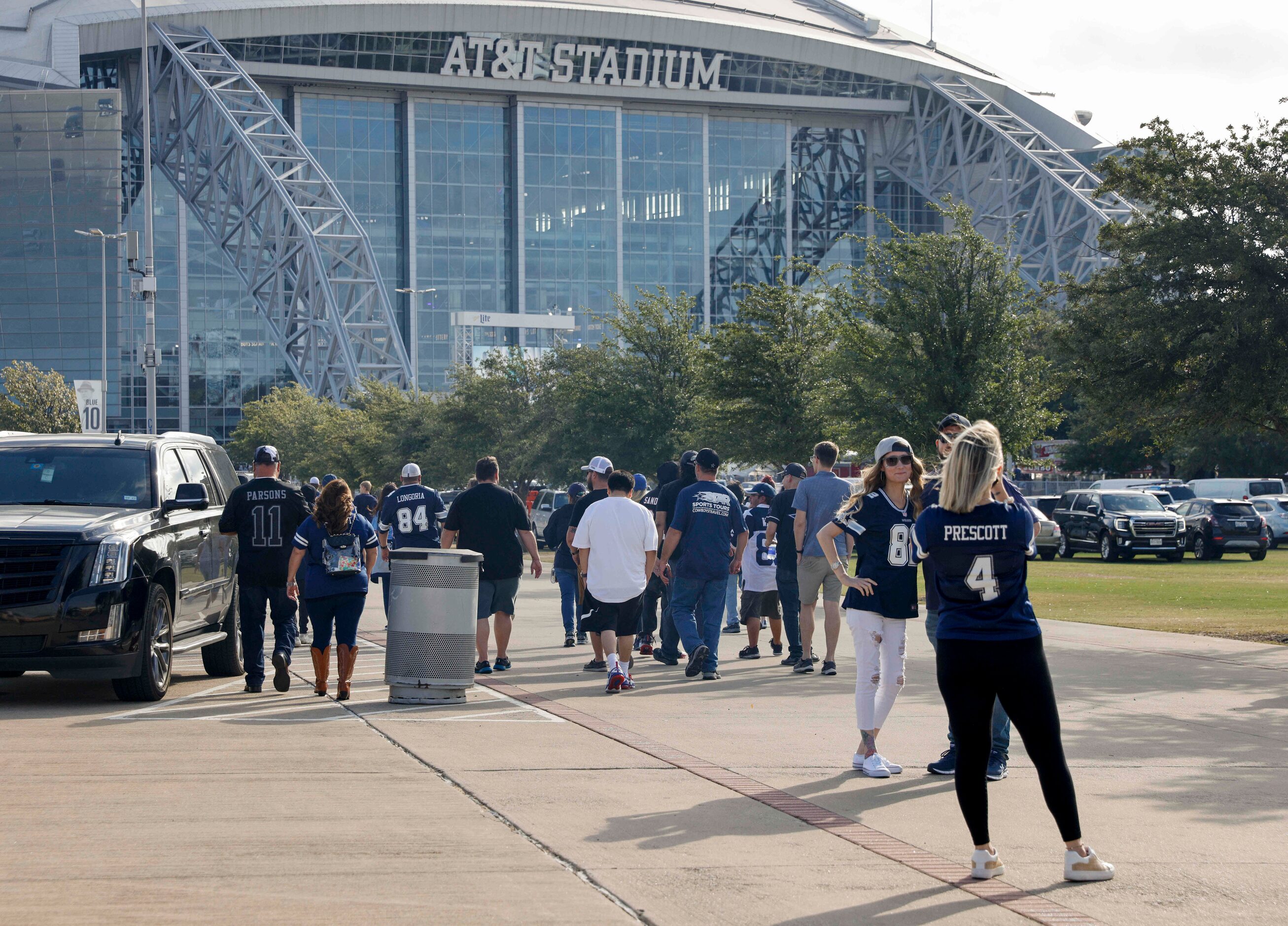 Fans make their way towards AT&T Stadium before a Dallas Cowboys and Detroit Lions game on...