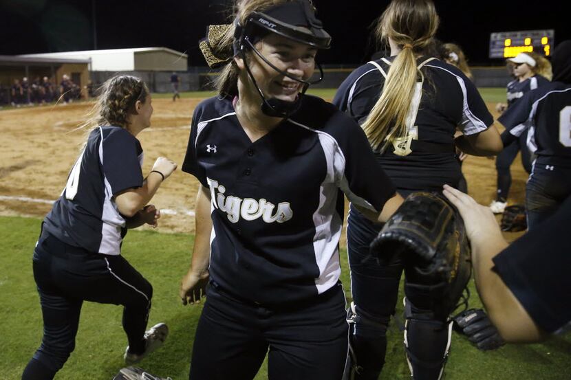 Mansfield pitcher Paxton Scheurer was all smiles as she was congratulated after a playoff...