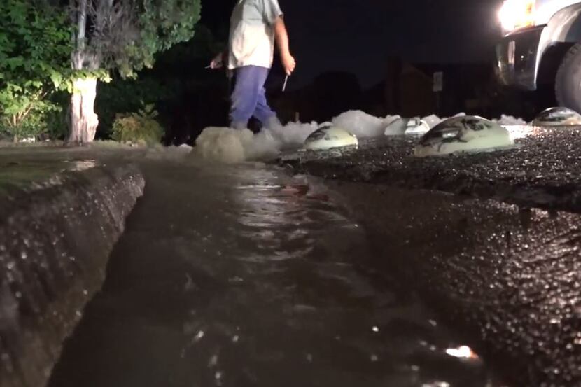 Water gushes into the street after an 8-inch line broke early Tuesday in University Park.