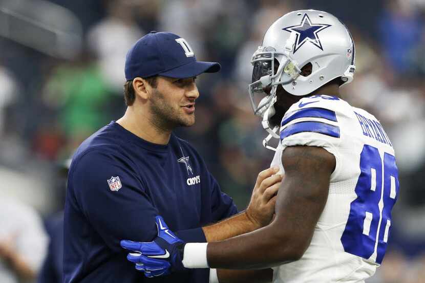 Dallas Cowboys quarterback Tony Romo (9) talks with Dallas Cowboys wide receiver Dez Bryant...