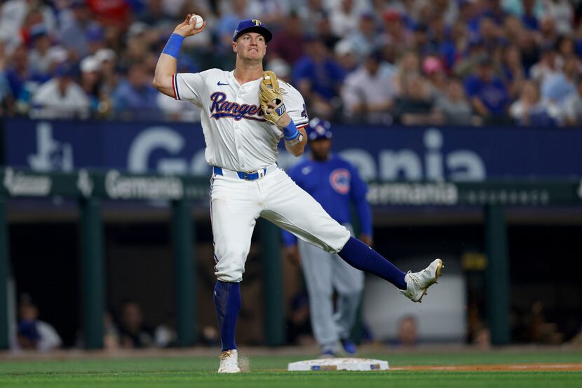 Texas Rangers third baseman Josh Jung (6) fields a single from Chicago Cubs third baseman...