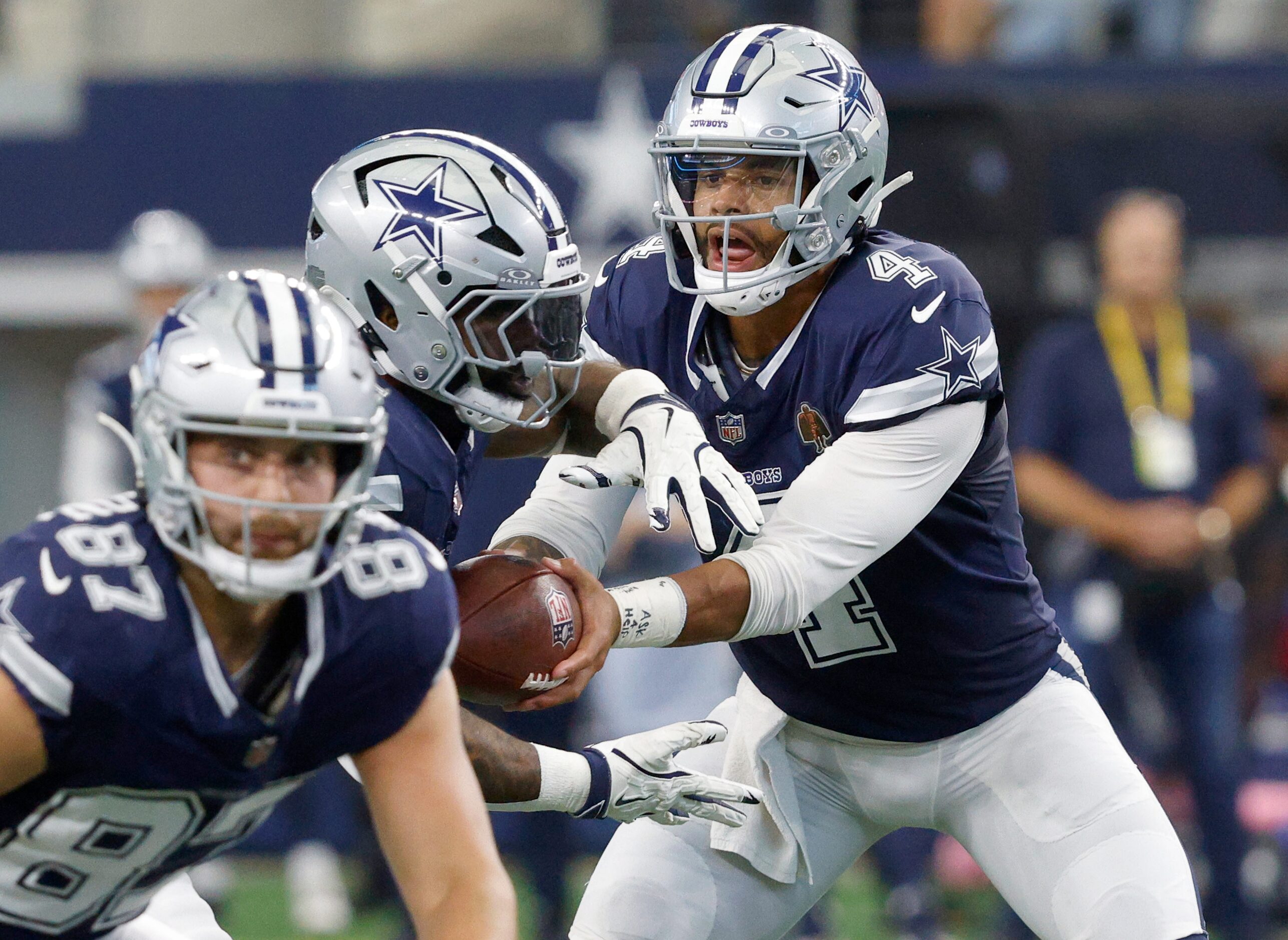 Dallas Cowboys quarterback Dak Prescott (4) hands off to Dallas Cowboys running back Ezekiel...