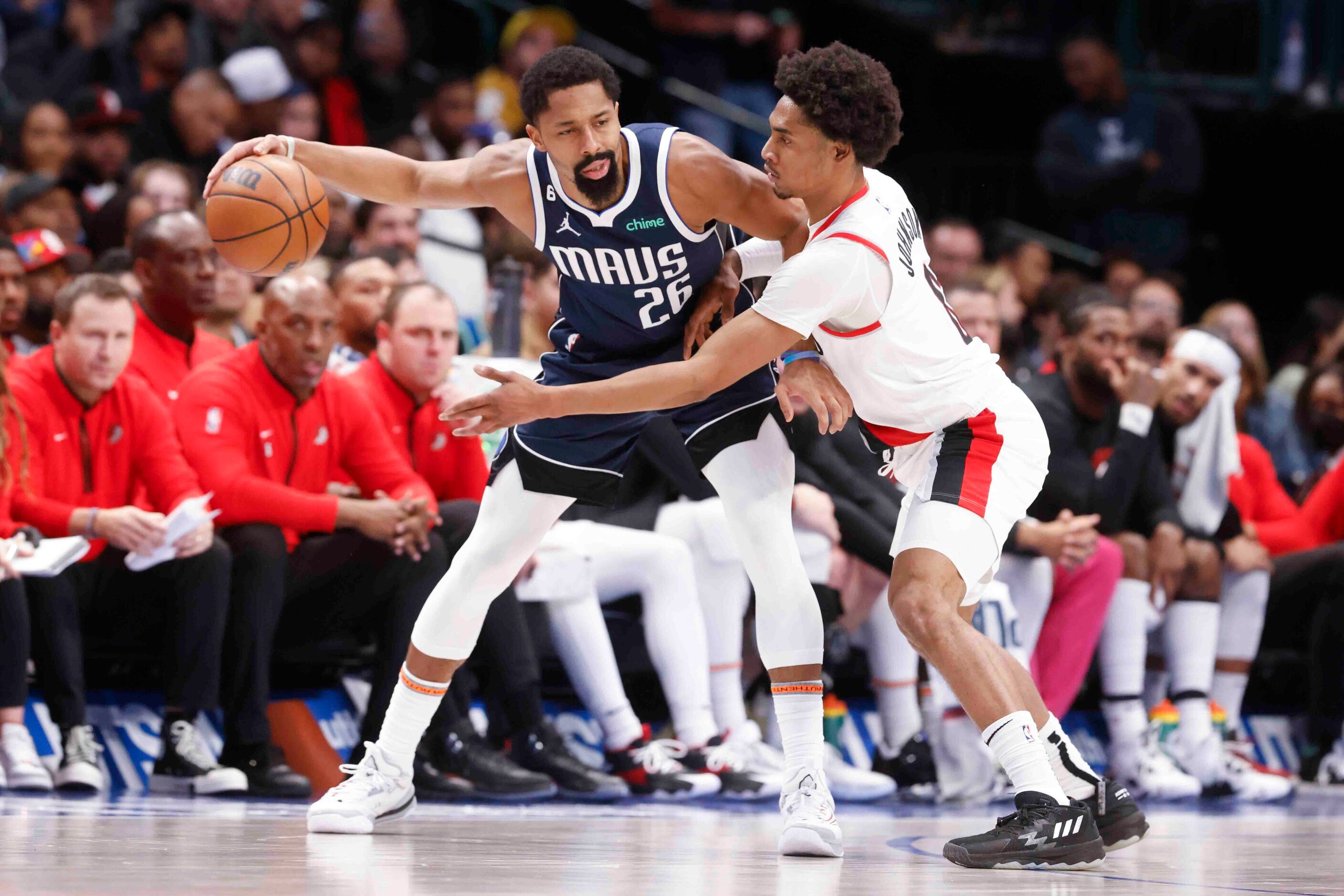 Dallas Mavericks guard Spencer Dinwiddie (26) defends the ball against Portland Trail...