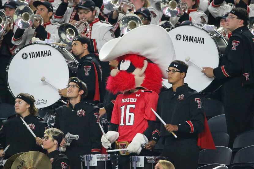 The Red Raiders mascot sits in with the Red Raider band drum line during a game against...