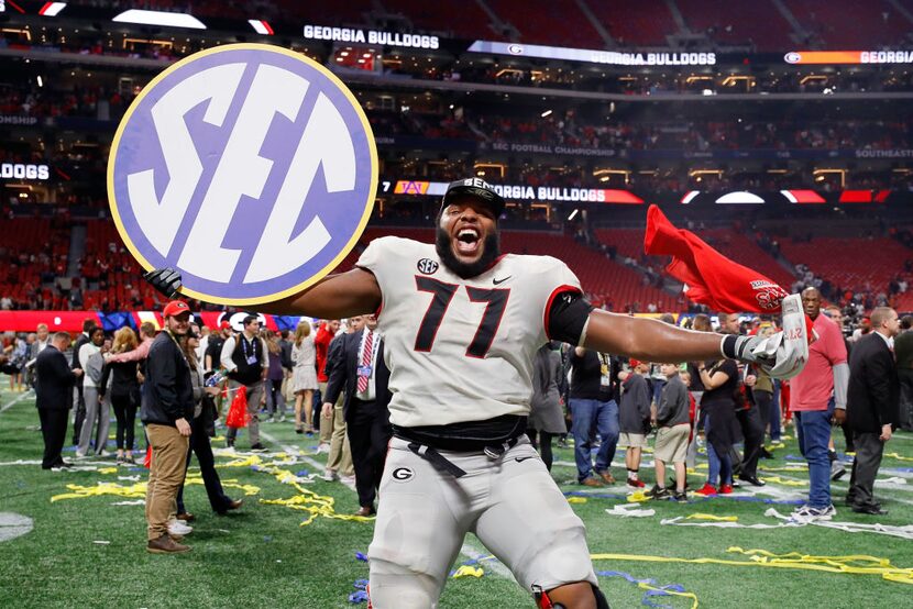 ATLANTA, GA - DECEMBER 02: Isaiah Wynn #77 of the Georgia Bulldogs celebrates beating the...