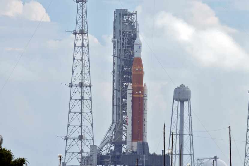 NASA's new moon rocket sits on Launch Pad 39-B minutes after the launch was scrubbed,...
