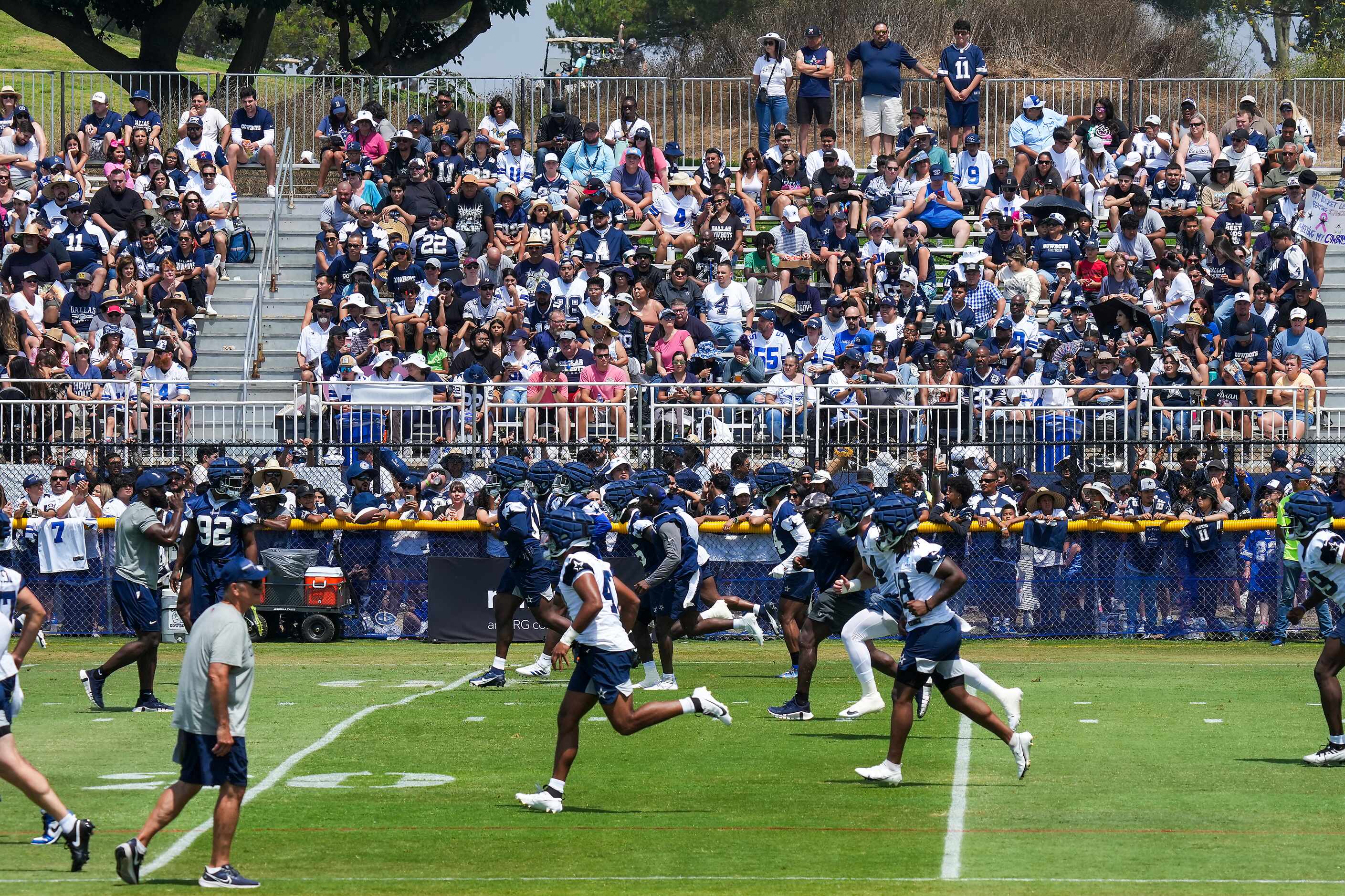 Fans watch Dallas Cowboys stretch during a training camp practice on Saturday, July 29,...