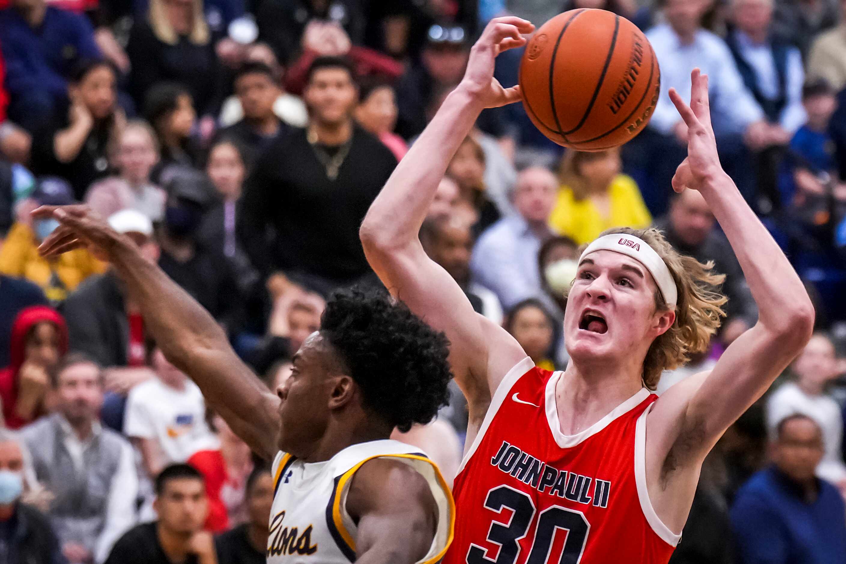 John Paul II's Liam McNeeley (30) drives to the basket as Prestonwood Christian's Nathan...