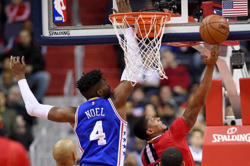 Washington Wizards guard Bradley Beal, right, goes to the basket against Philadelphia 76ers...