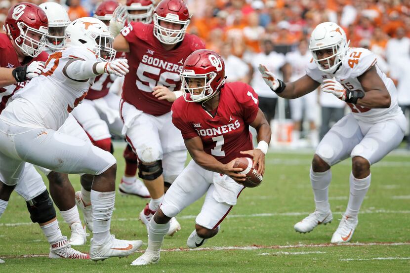 Oklahoma Sooners quarterback Kyler Murray (1) looks for room to run as he is pressured by...