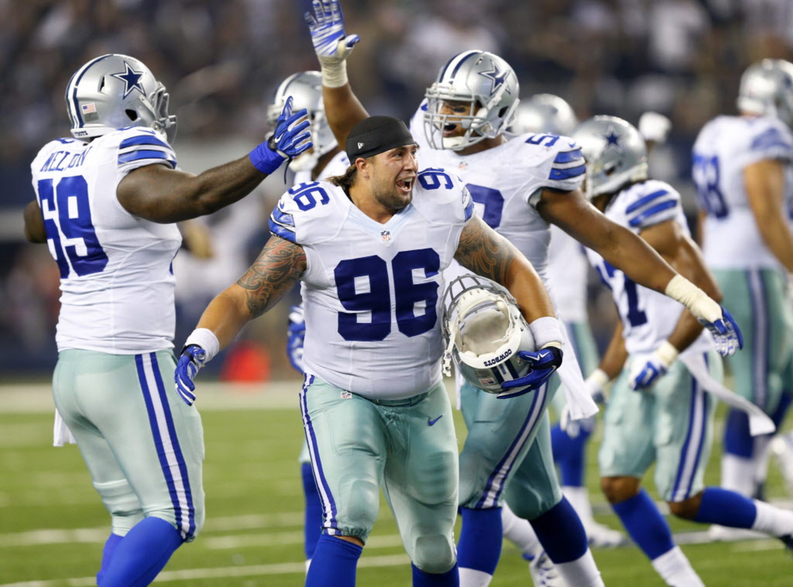 Dallas Cowboys defensive tackle Nick Hayden (96) and his teammates celebrate strong safety...