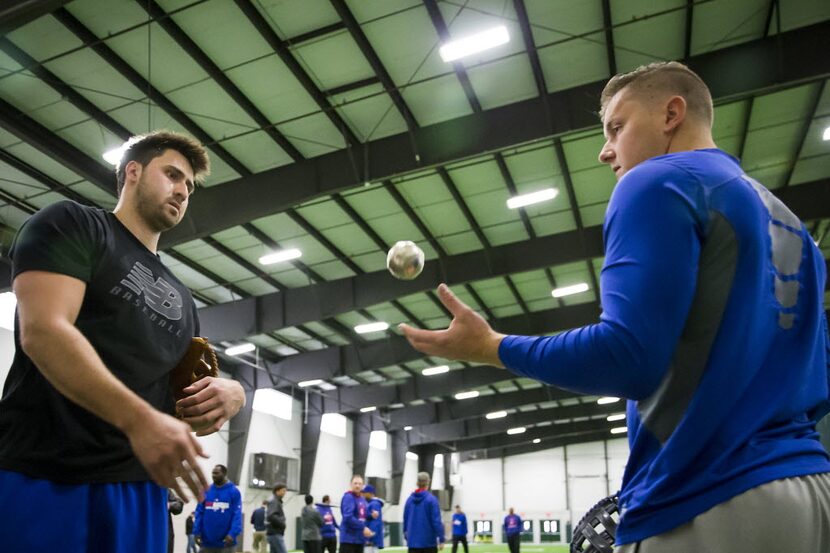 Texas Rangers infielder Joey Gallo (left) tosses a ball to Ryan Rua during the Rangers...