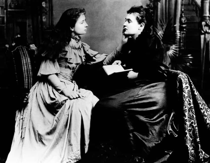 Helen Keller (left) "hears" Anne Sullivan by feeling the vibrations on her lips. 