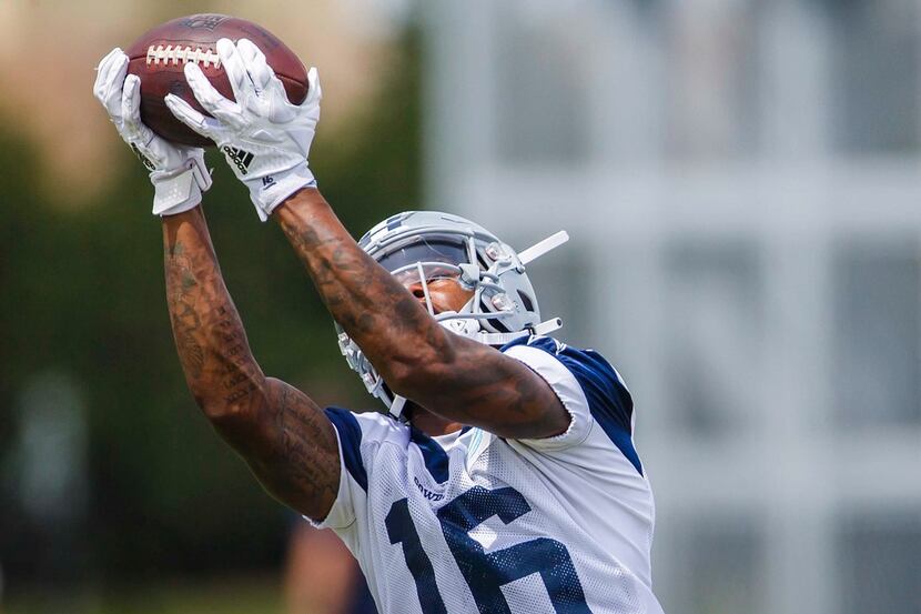 FILE - Cowboys wide receiver Cedrick Wilson catches a pass during minicamp at The Star on...