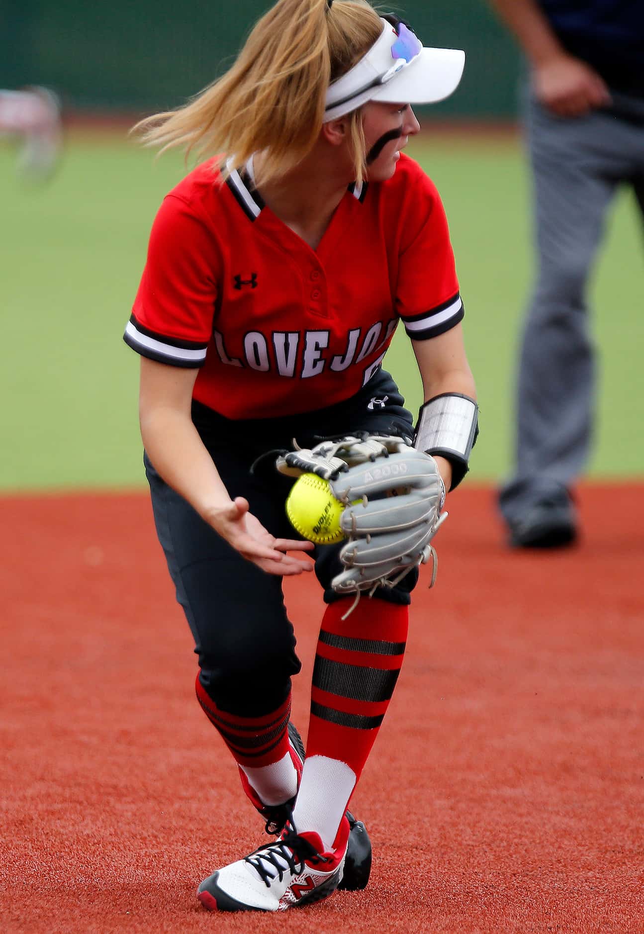 Lovejoy shortstop Skylar Rucker (5) makes the stop before making an underhand toss to second...